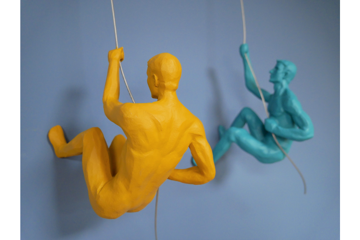 Climbing men coloured sculpture